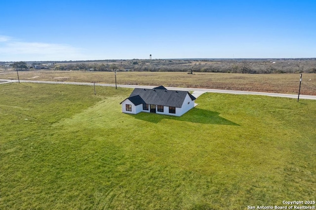 birds eye view of property with a rural view