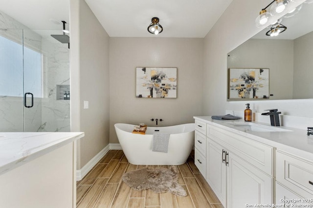 bathroom featuring vanity and independent shower and bath