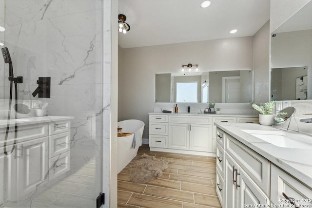 bathroom featuring vanity and a tub