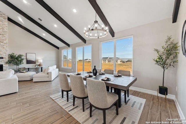 dining space featuring a notable chandelier, a healthy amount of sunlight, high vaulted ceiling, and beamed ceiling