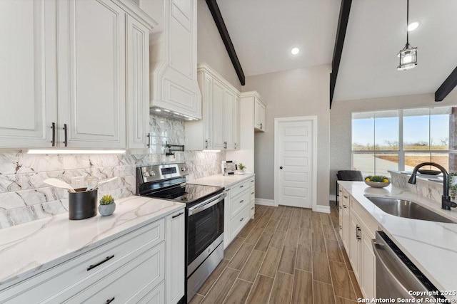 kitchen featuring stainless steel appliances, lofted ceiling with beams, white cabinets, and decorative light fixtures