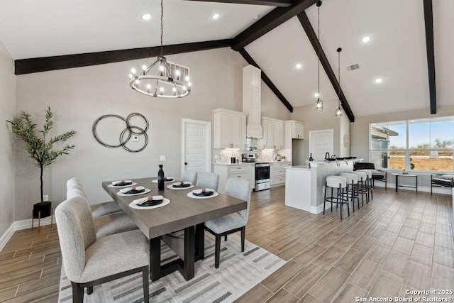 dining space featuring beamed ceiling, high vaulted ceiling, and a chandelier