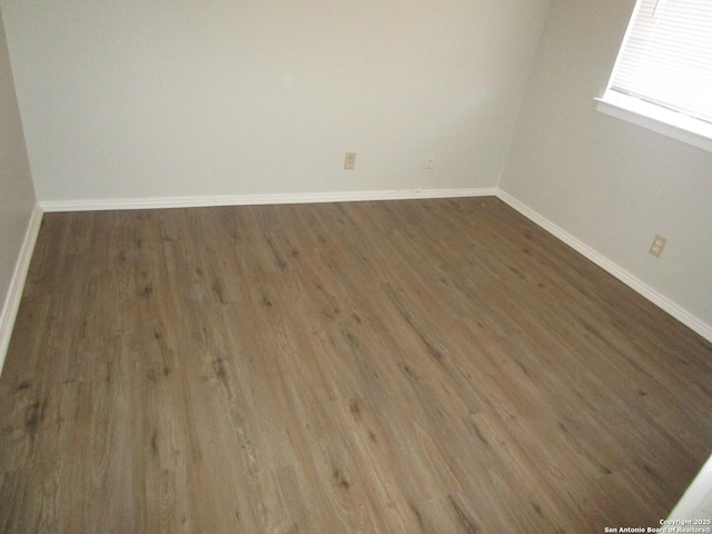 spare room with dark wood-type flooring