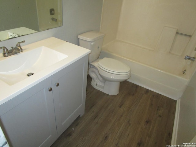 full bathroom with toilet, shower / tub combination, wood-type flooring, and vanity