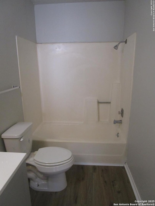 full bathroom with toilet, vanity, hardwood / wood-style floors, and bathtub / shower combination