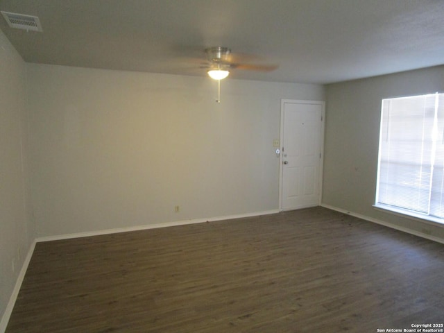 spare room with ceiling fan and dark hardwood / wood-style floors