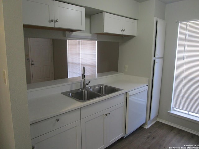 kitchen with white cabinets, dark wood-type flooring, dishwasher, and sink