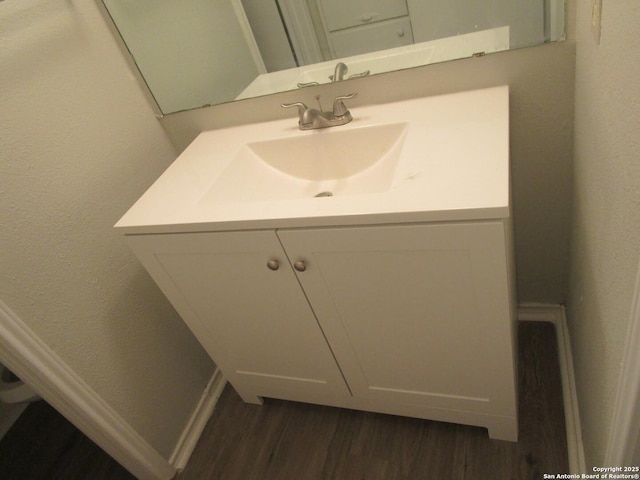 bathroom featuring hardwood / wood-style floors and vanity