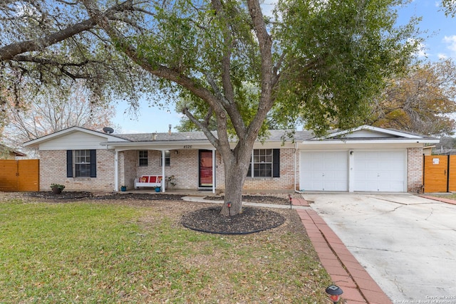 ranch-style house featuring a garage and a front lawn