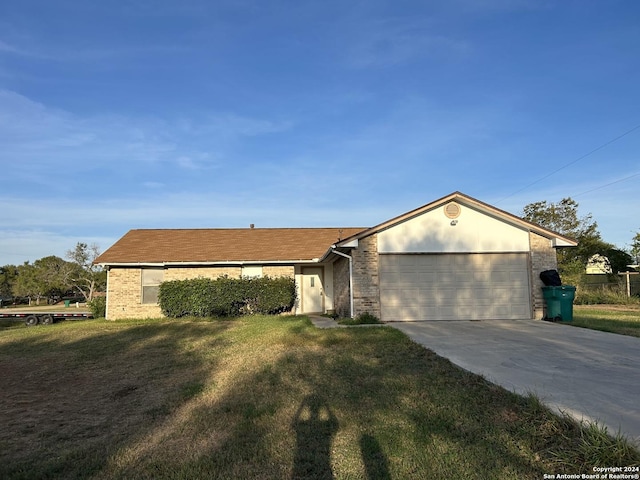 ranch-style house featuring a front lawn and a garage