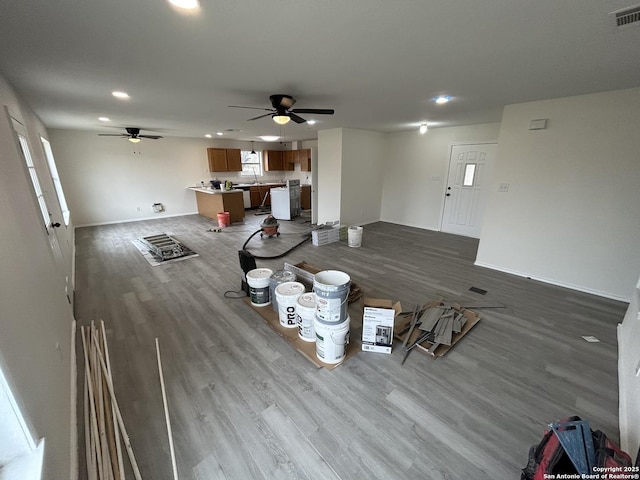 unfurnished dining area featuring ceiling fan and wood-type flooring