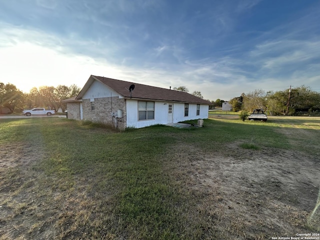 view of side of property with a yard