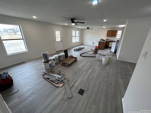 living room featuring ceiling fan and light hardwood / wood-style floors