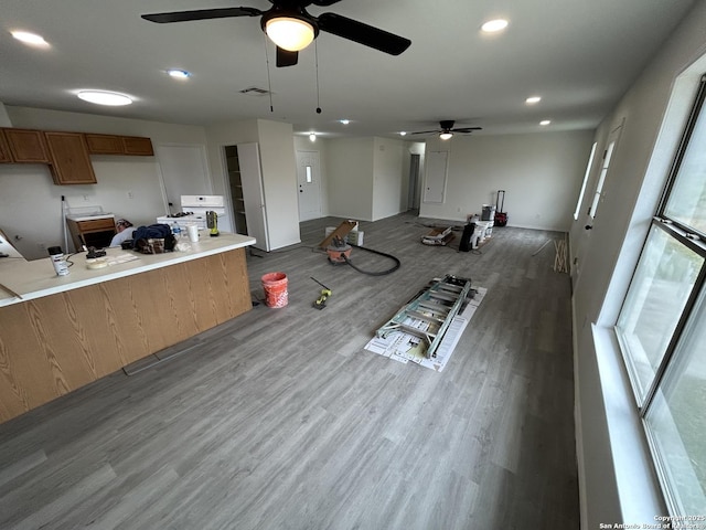 interior space featuring kitchen peninsula, hardwood / wood-style flooring, and a wealth of natural light