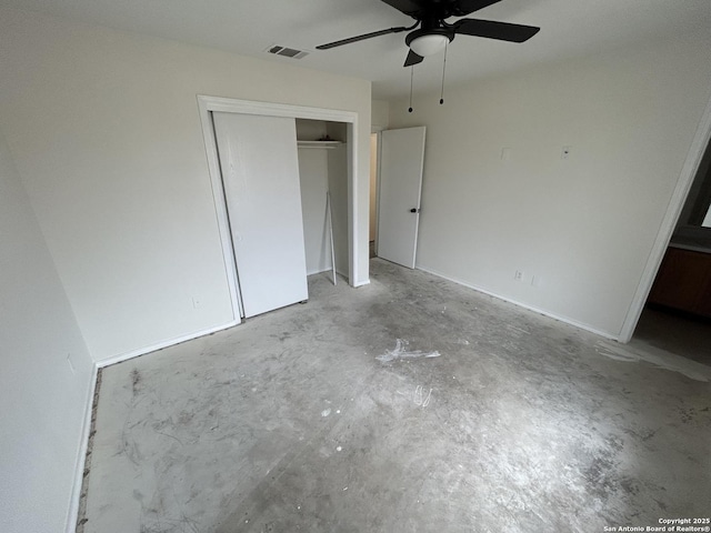 unfurnished bedroom with concrete flooring, a closet, and ceiling fan