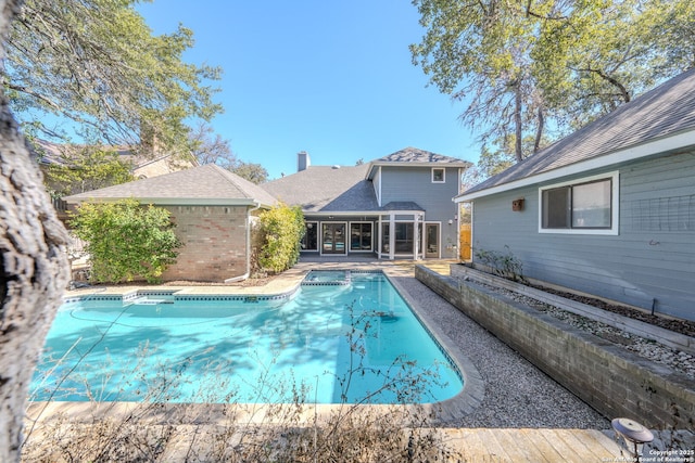 outdoor pool featuring a sunroom