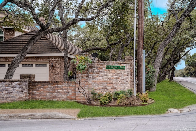 community / neighborhood sign with a garage