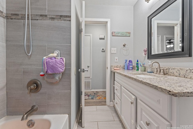 bathroom featuring vanity, tiled shower / bath combo, and tile patterned floors