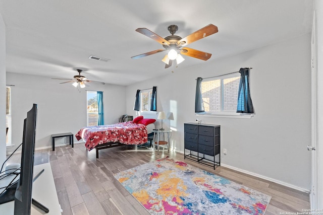 bedroom with ceiling fan and light hardwood / wood-style floors