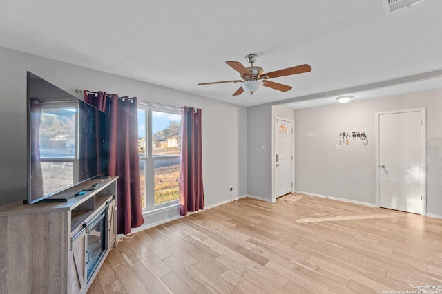 unfurnished living room featuring ceiling fan and light hardwood / wood-style flooring