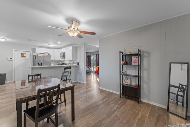 dining space featuring ceiling fan and hardwood / wood-style flooring