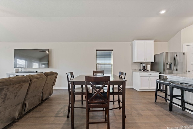 dining room with lofted ceiling and dark hardwood / wood-style floors