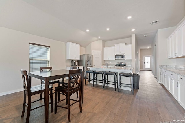 dining room with a healthy amount of sunlight and dark hardwood / wood-style floors