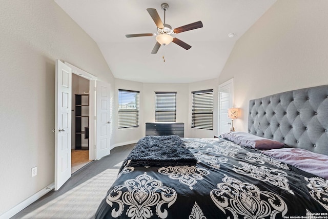 bedroom with ceiling fan, lofted ceiling, and dark carpet