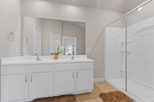 bathroom featuring vanity, tile patterned floors, and a shower with shower door