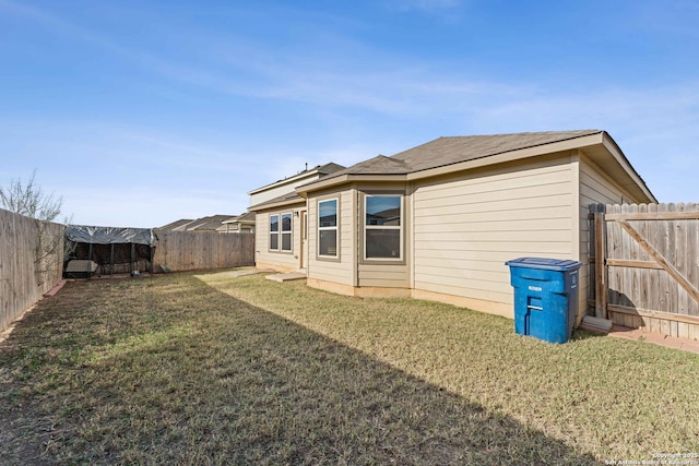 back of house featuring a lawn