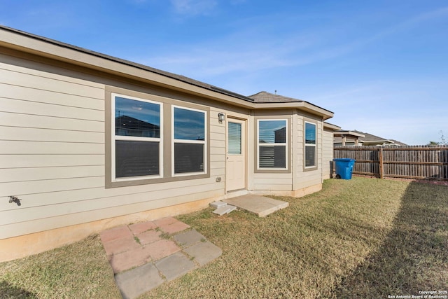 rear view of property with a yard