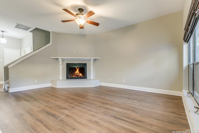 unfurnished living room with ceiling fan and light hardwood / wood-style flooring