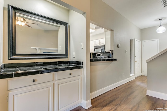 bathroom with vanity, hardwood / wood-style floors, and ceiling fan