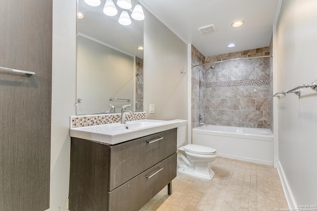 full bathroom featuring toilet, crown molding, backsplash, tiled shower / bath, and vanity