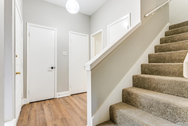 stairs with hardwood / wood-style flooring