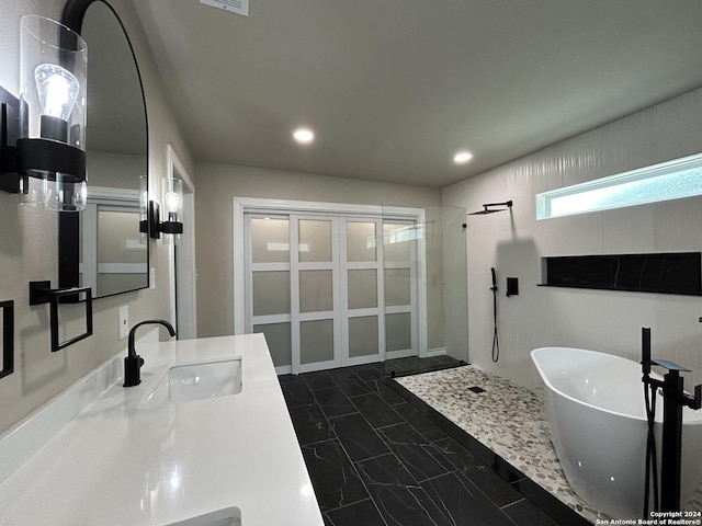 bathroom featuring tiled shower and vanity