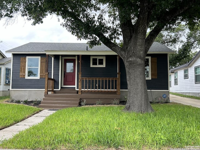 bungalow-style house with a porch and a front yard