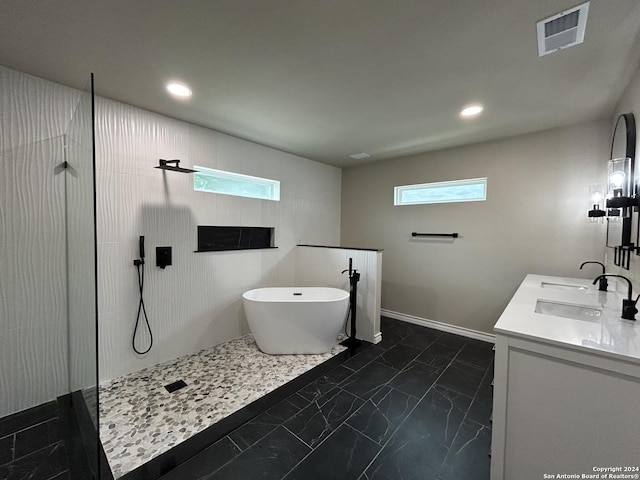 bathroom with vanity and shower with separate bathtub