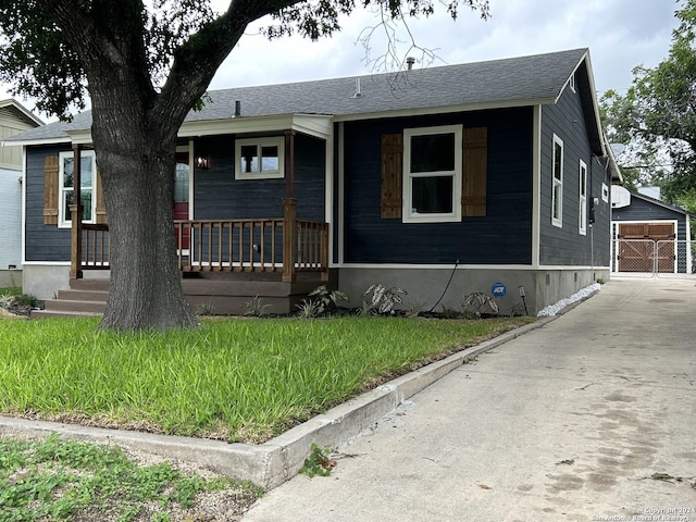 view of front of home with a front yard and covered porch