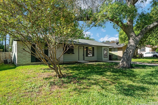 view of front of house featuring a front yard and central AC unit