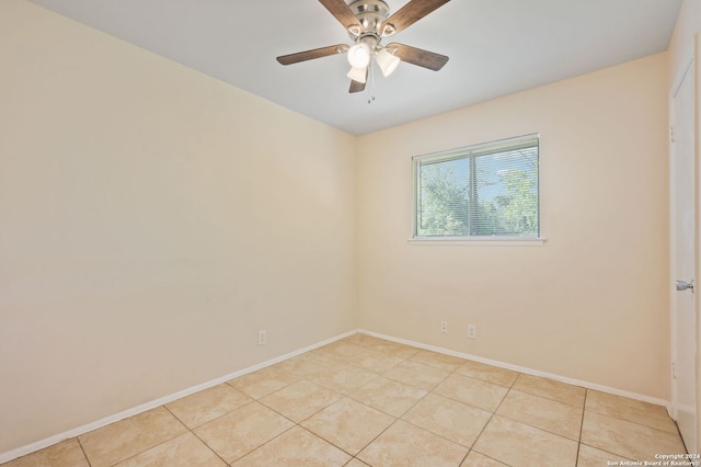 empty room with light tile patterned flooring and ceiling fan