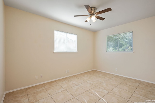 empty room with a wealth of natural light and light tile patterned floors