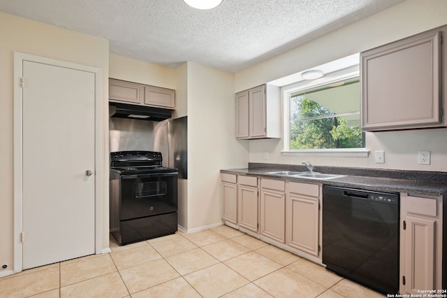 kitchen with a textured ceiling, black appliances, gray cabinetry, light tile patterned flooring, and sink