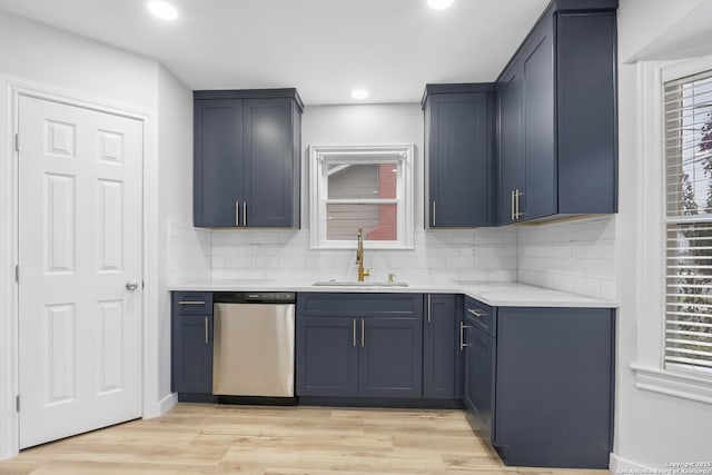 kitchen featuring sink, dishwasher, plenty of natural light, and light hardwood / wood-style flooring