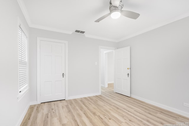 unfurnished bedroom with ceiling fan, light wood-type flooring, and ornamental molding