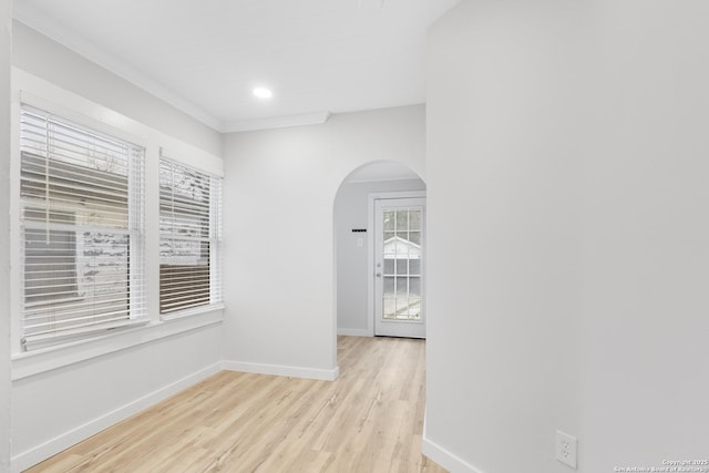 hall featuring crown molding and light hardwood / wood-style flooring