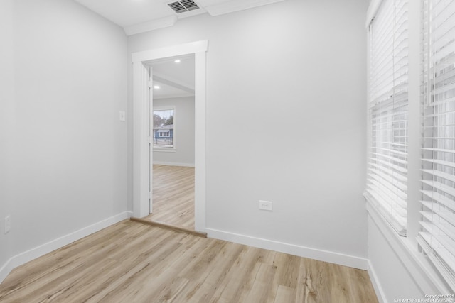 unfurnished room featuring crown molding and light hardwood / wood-style flooring