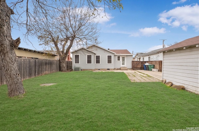 rear view of house featuring a patio, central AC unit, and a lawn