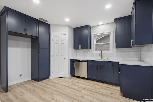 kitchen featuring stainless steel dishwasher, light hardwood / wood-style flooring, tasteful backsplash, blue cabinetry, and sink