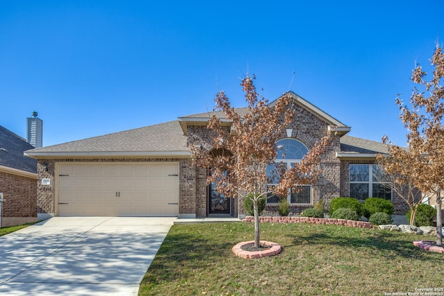 view of front of house with a front yard and a garage